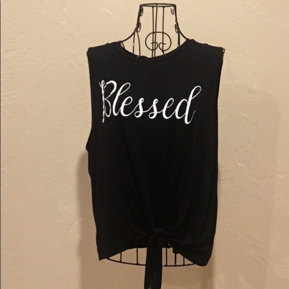 Black top, white, words, tied at the bottom front